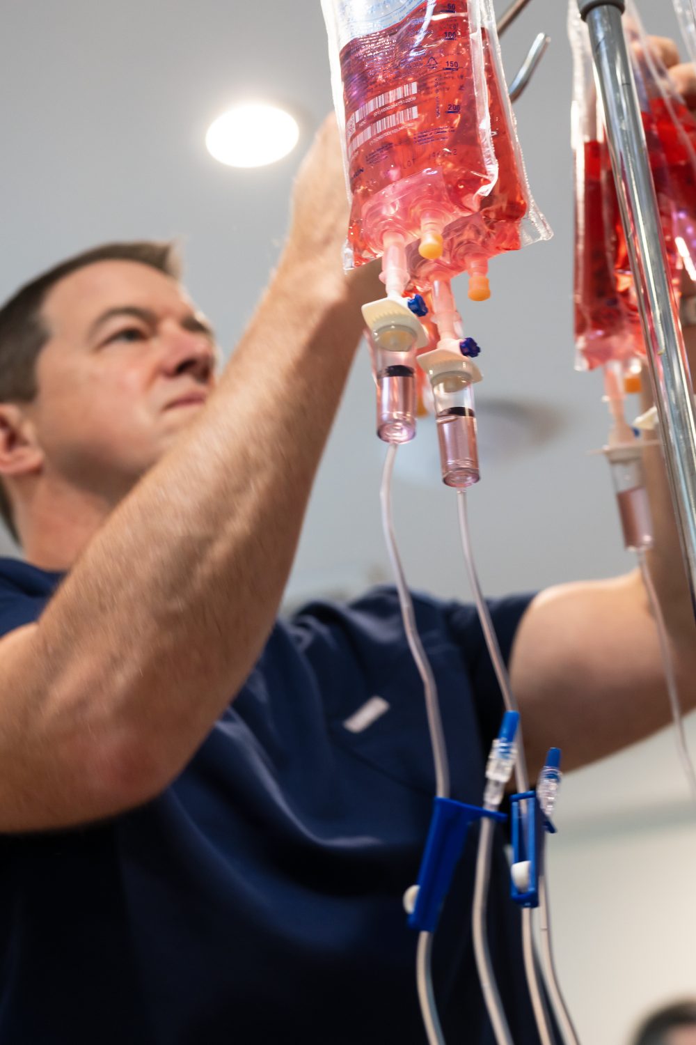 A YNC team member prepares an IV