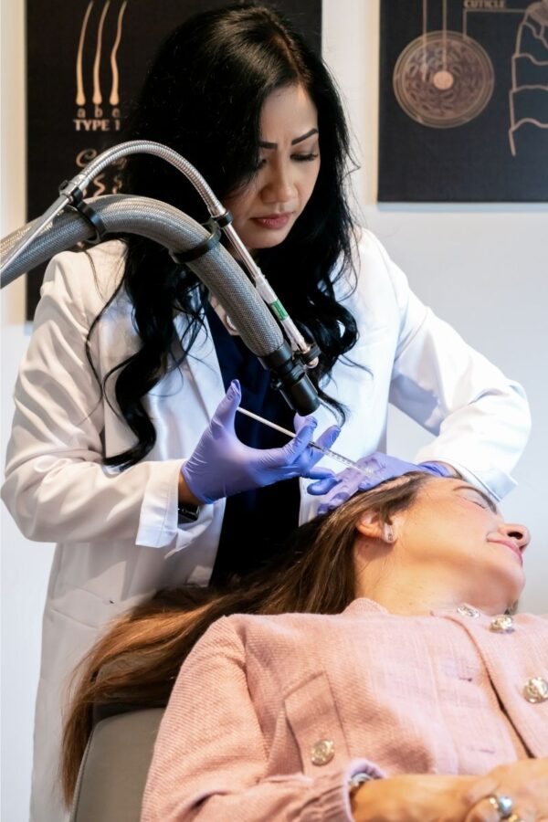 A YNC doctor performs a scalp treatment