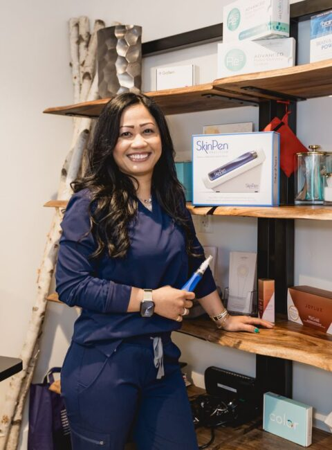 A YNC team member holds a SkinPen microneedling device